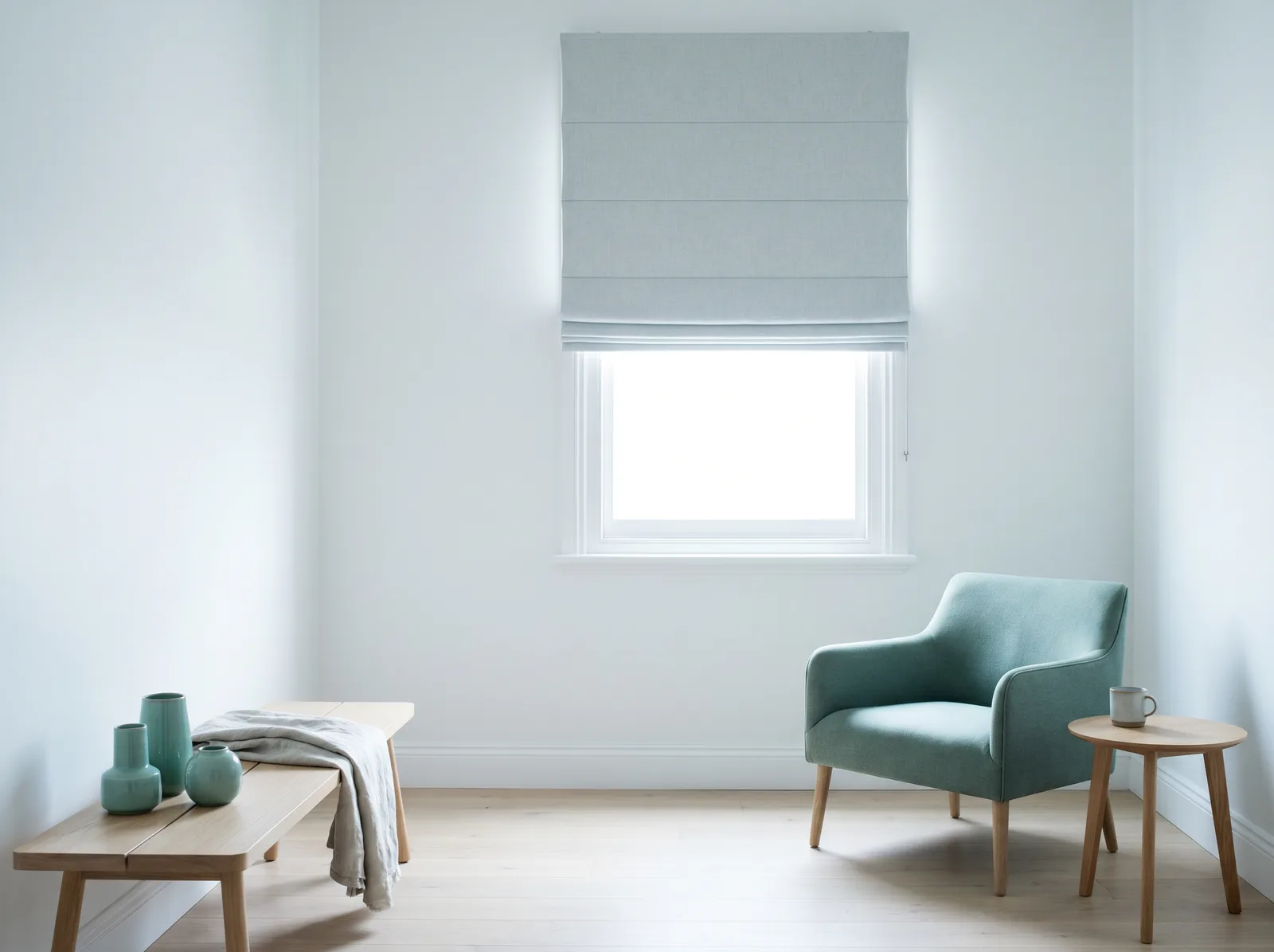 Pale roman blind half-raised in neat folds in a cottage window